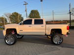 Side profile Brianna's lifted Silverado High Country with pink suspension and chrome wheels photo 5