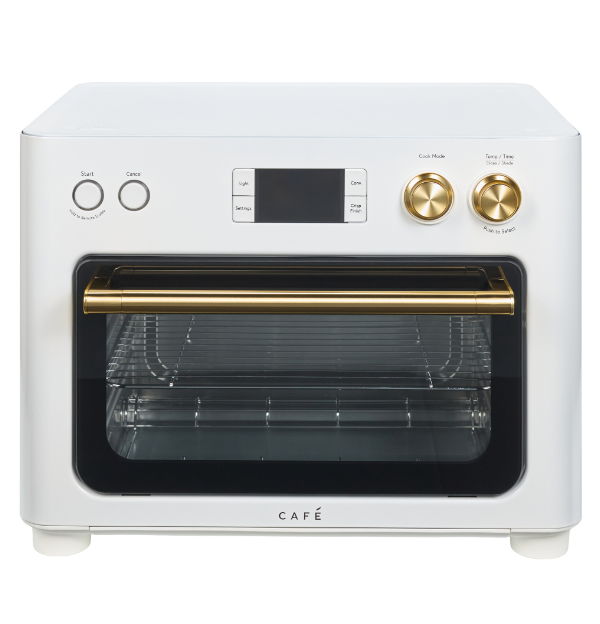 White countertop oven with gold knobs and digital display.