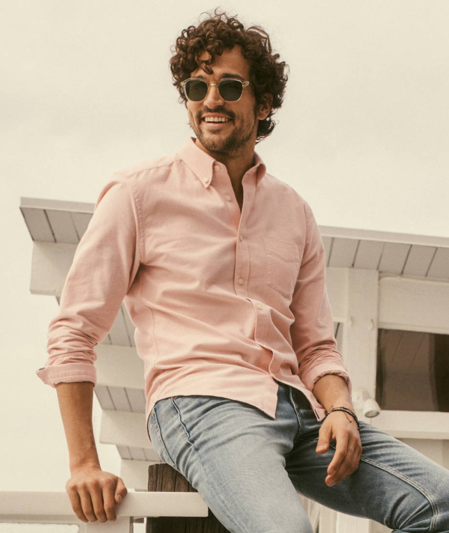 Model is wearing UNTUCKit Peach Picarden button down. 