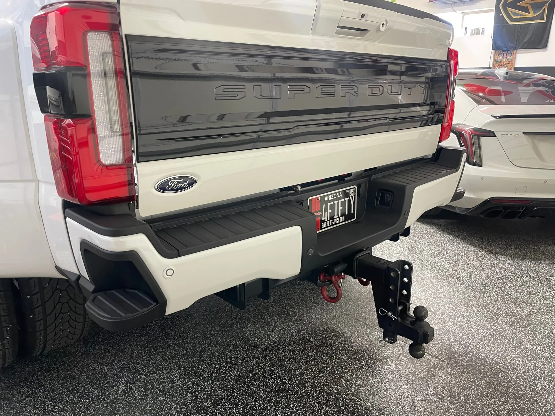 Rear view Robert's 2025 Ford F450 Super Duty dually with 4FIFTY Barrett-Jackson plate and drop hitch photo 1
