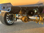 Rear axle view with air tank and train horn mounted under Brianna's lifted Silverado photo 3