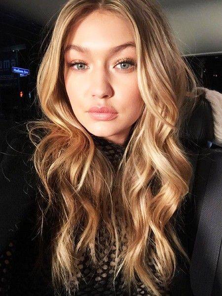 Gigi Hadid with curly hair and subtle layers