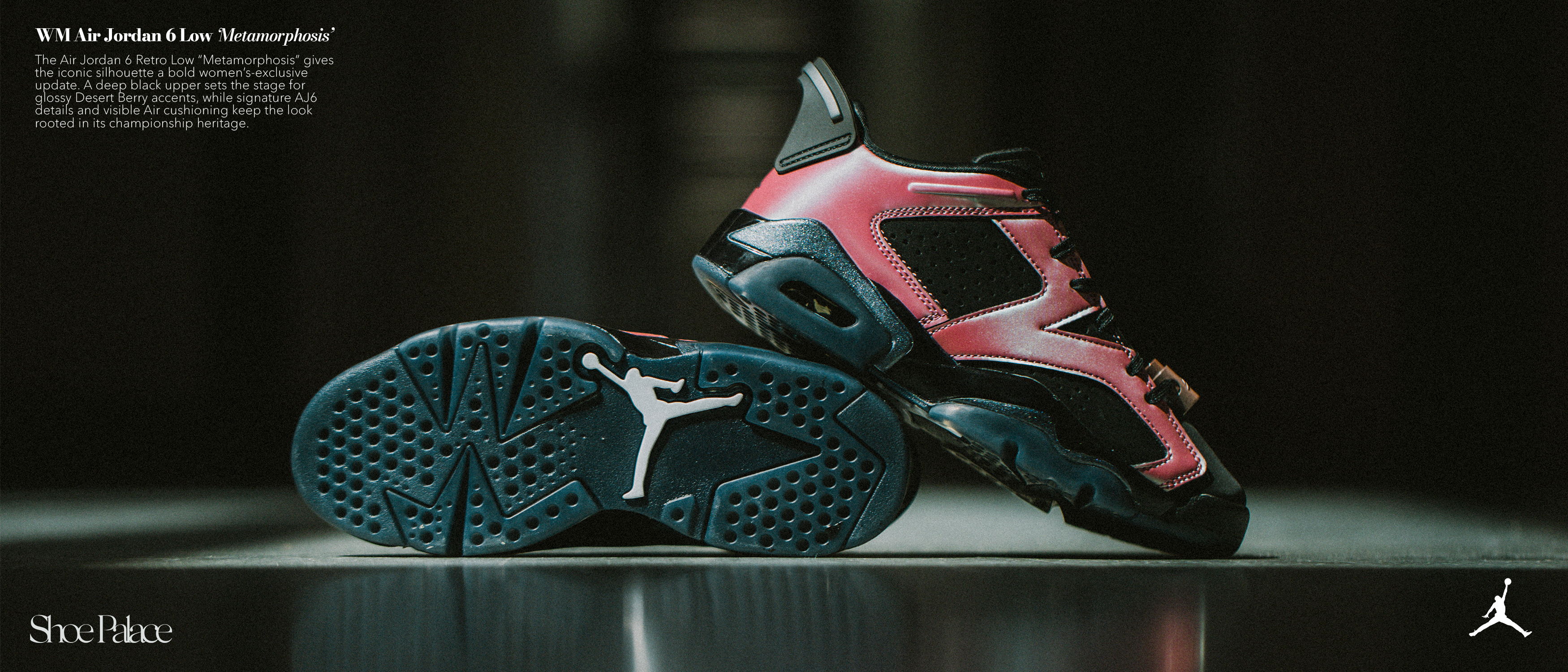 A pair of pink and black athletic shoes on a reflective surface.