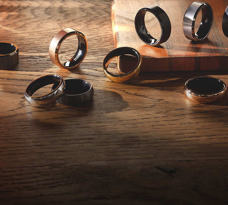 Various rings displayed on a wooden surface.