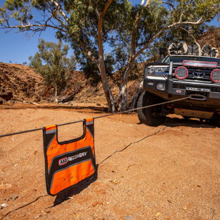 Toyota off-road vehicle with winch and recovery damper, lifestyle image.