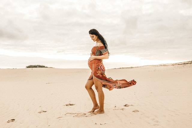 Pregnant Woman On The Beach