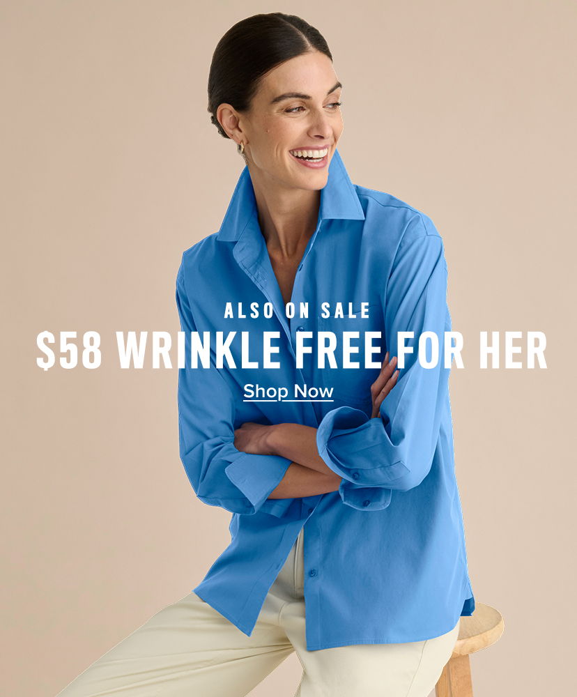 Woman smiling in a blue shirt, promoting wrinkle-free clothing for sale.