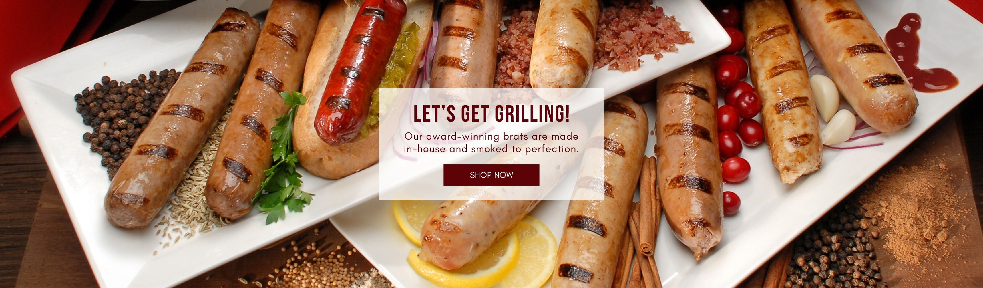 Grilled bratwursts and sausages on a white platter