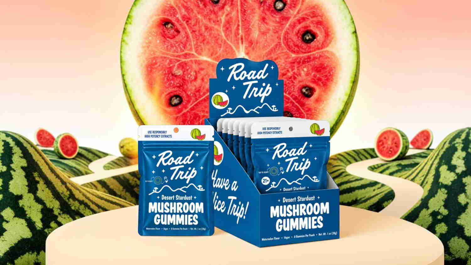 Boxes of mushroom gummies with a watermelon backdrop.
