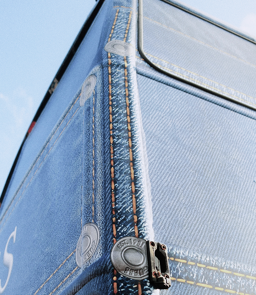Close-up of a blue fabric corner with stitching and a clasp.