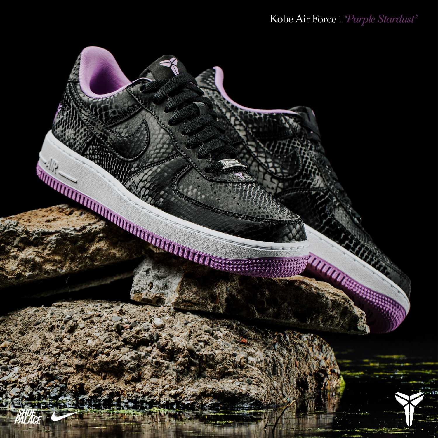 Black and purple Nike Air Force 1 shoes displayed on a rocky surface.