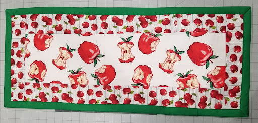 The finished diy Table Runner with red and green apple fabrics