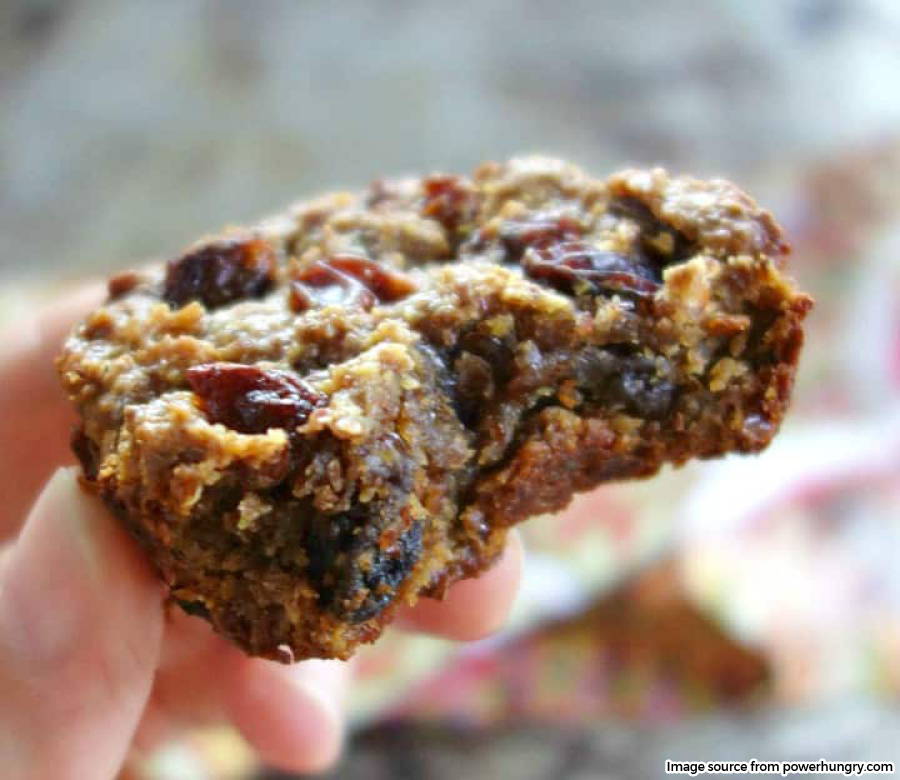 image of hand holding cookie with bite in it