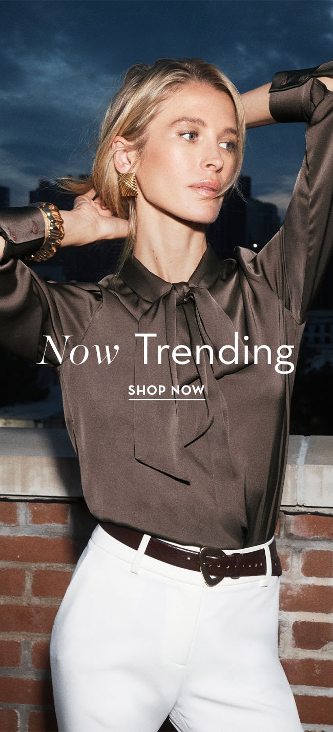 Model in stylish blouse promoting trending fashion.