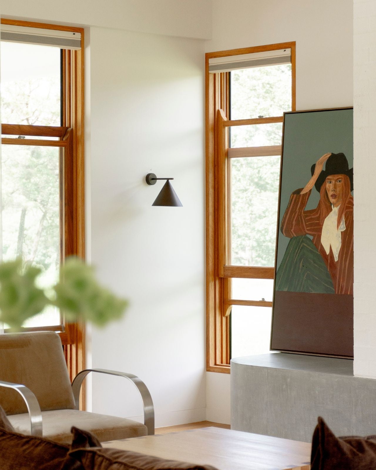 Straight Arm Iron Cone Wall Light in an artist room 