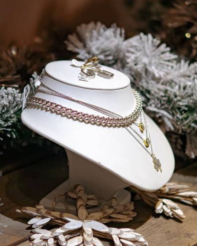 Jewelry display on a pedestal surrounded by festive decorations.