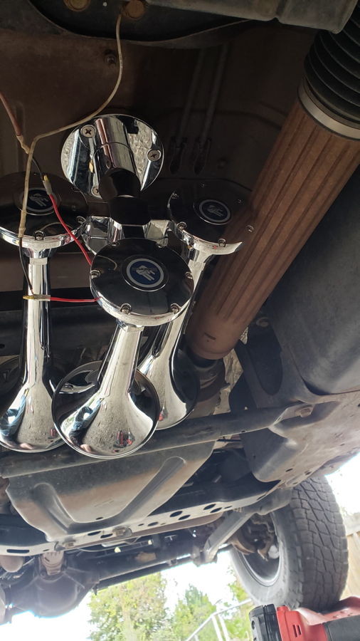 Undercarriage view chrome Outlaw train horn trumpets mounted on bracket Alvin's 2013 Jeep Rubicon HornBlasters install gallery photo 4