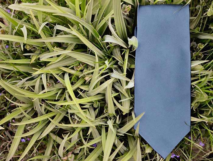 Dusty blue necktie, solid, in grass