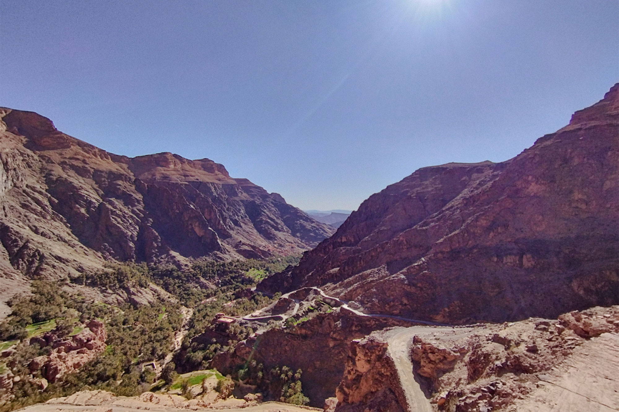 View from the top of a climb, mountains and a switchback gravel trail