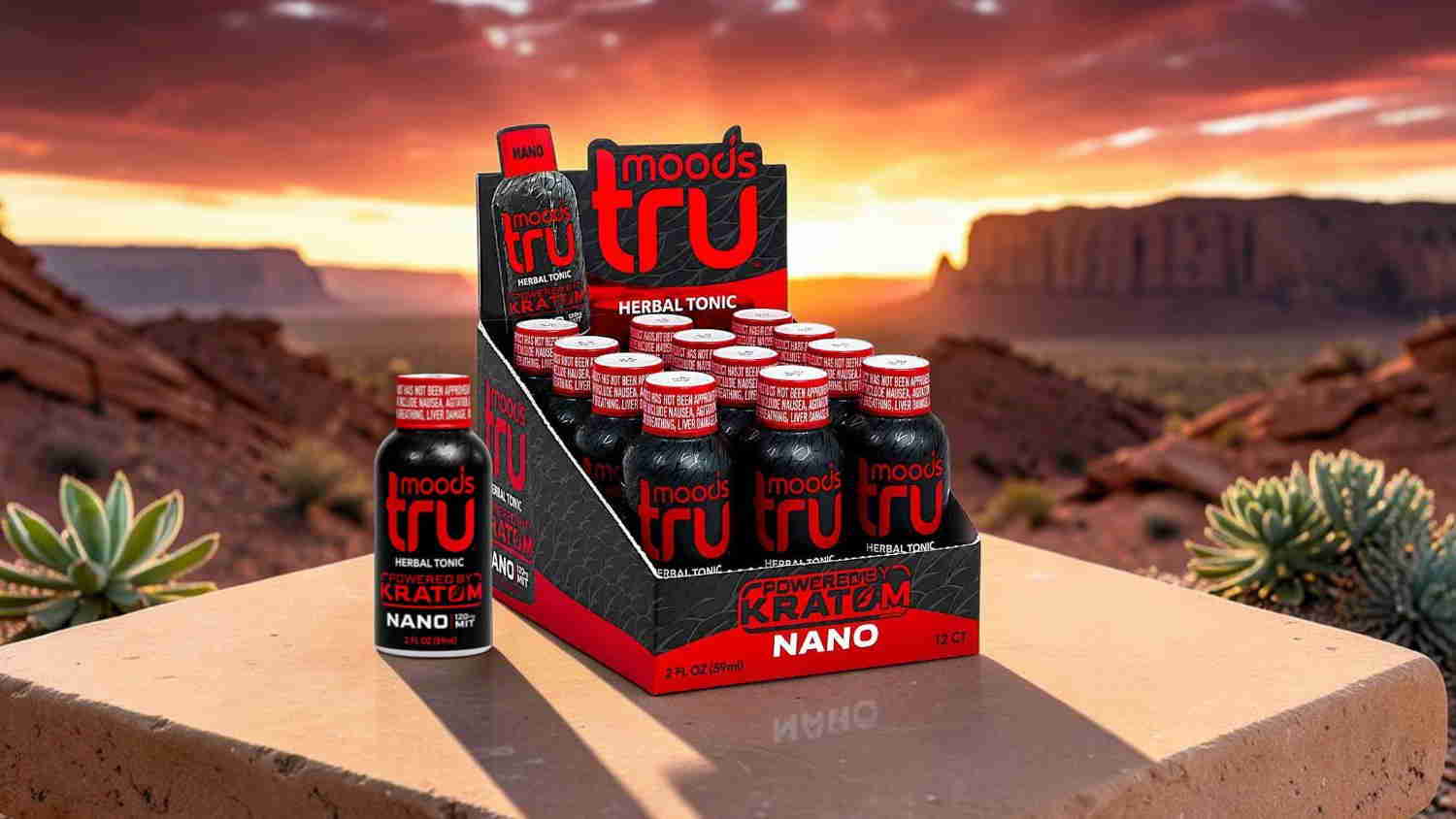 Display of energy drink bottles against a scenic desert sunset background.