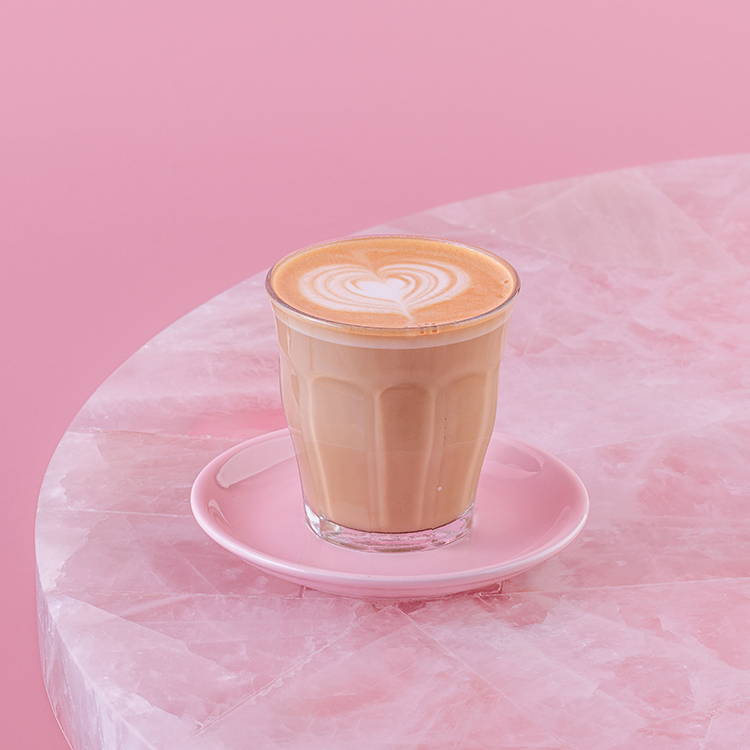 Classic Spanish Latte coffee on pink background
