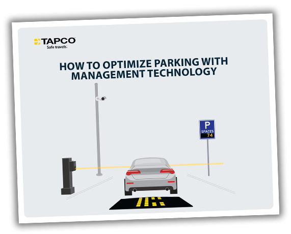 Car approaching a parking area with management technology signage.