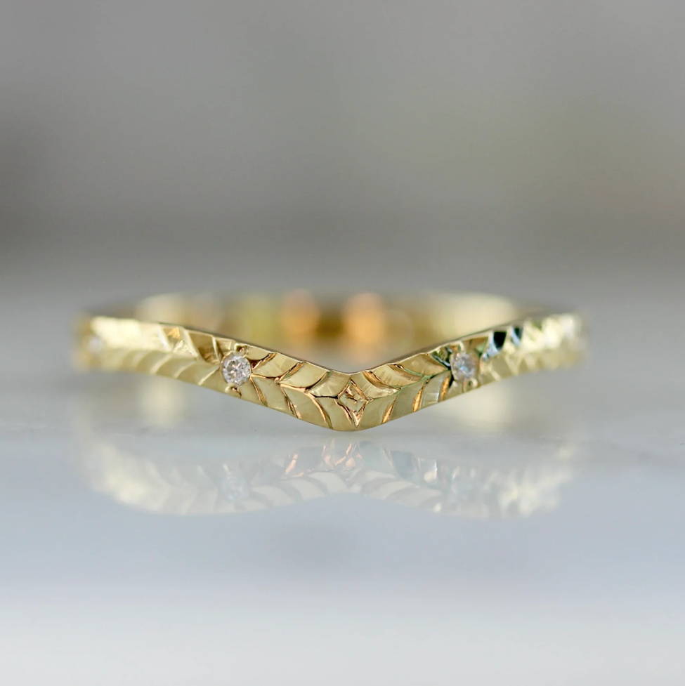 curved gold band with inset diamonds