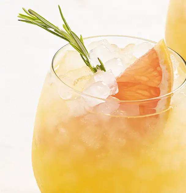 Refreshing orange beverage with Opal Nugget ice, topped with garnish and orange peel.