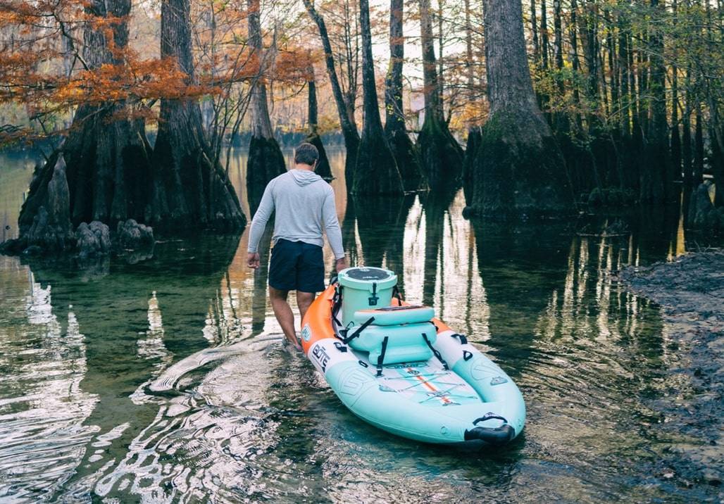 man taking a kayak to water