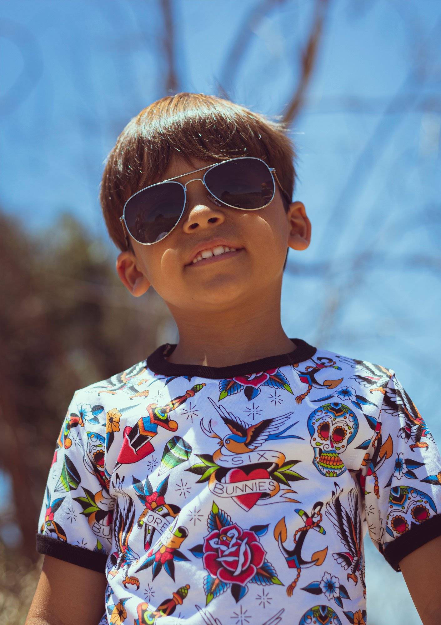 Young boy in sunglasses and graphic tee