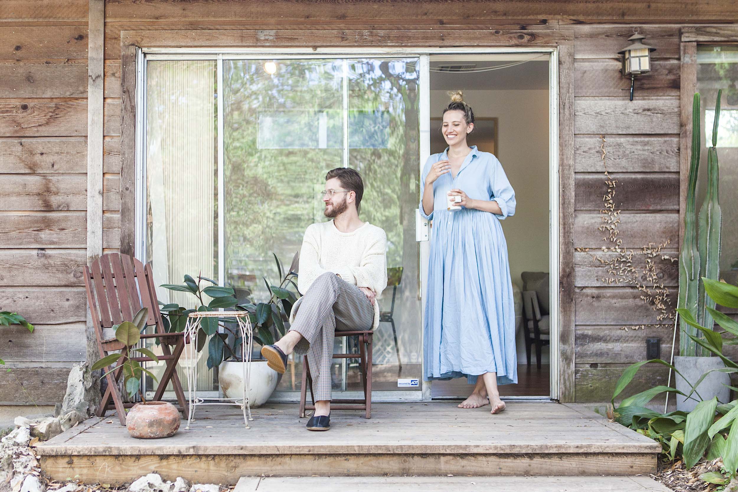 Couple outside on porch with eclectic mix of outdoor furniture