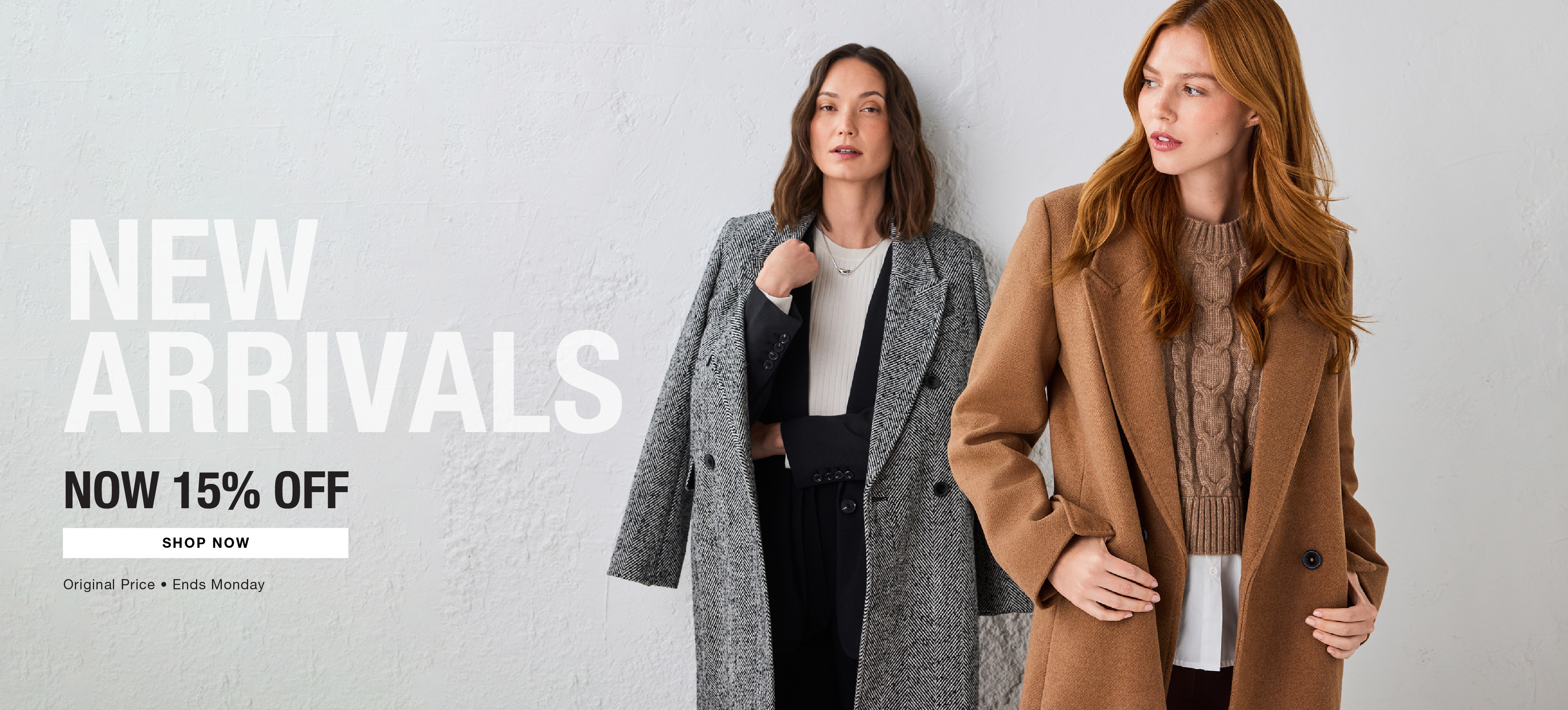 Two women modeling new outerwear against a neutral background.