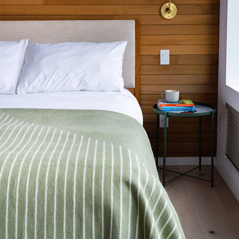 Sage SoftWool Blanket on bed