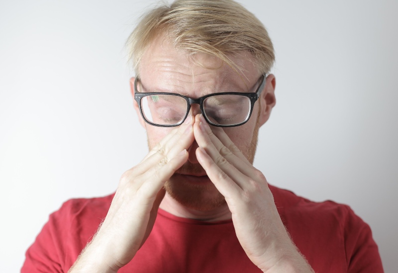 glasses wearer man dealing with glasses-related skin allergy