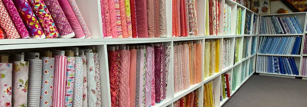 Herrschners Retail Store: image of fabric bolts stocked in shelves