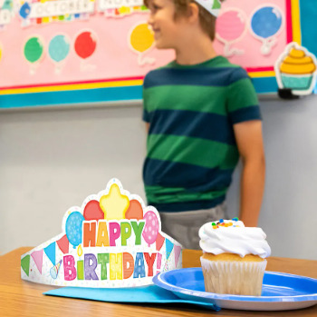Classroom Happy Birthday Crown on classroom desk next to cupcake