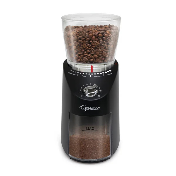 Black coffee grinder with transparent container for coffee beans on top.