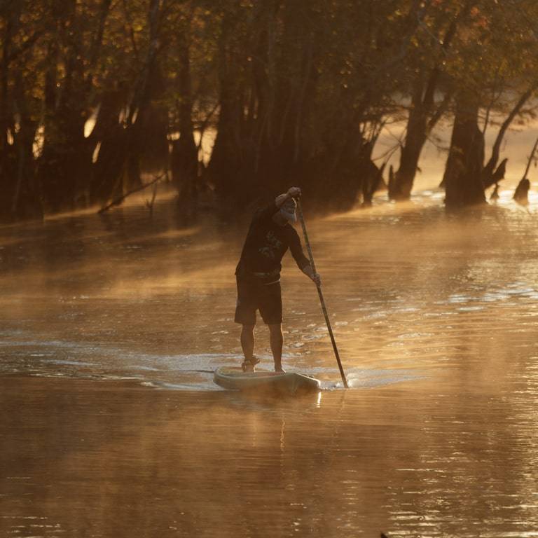 Man paddling his Rackham Verge Camo in the early morning