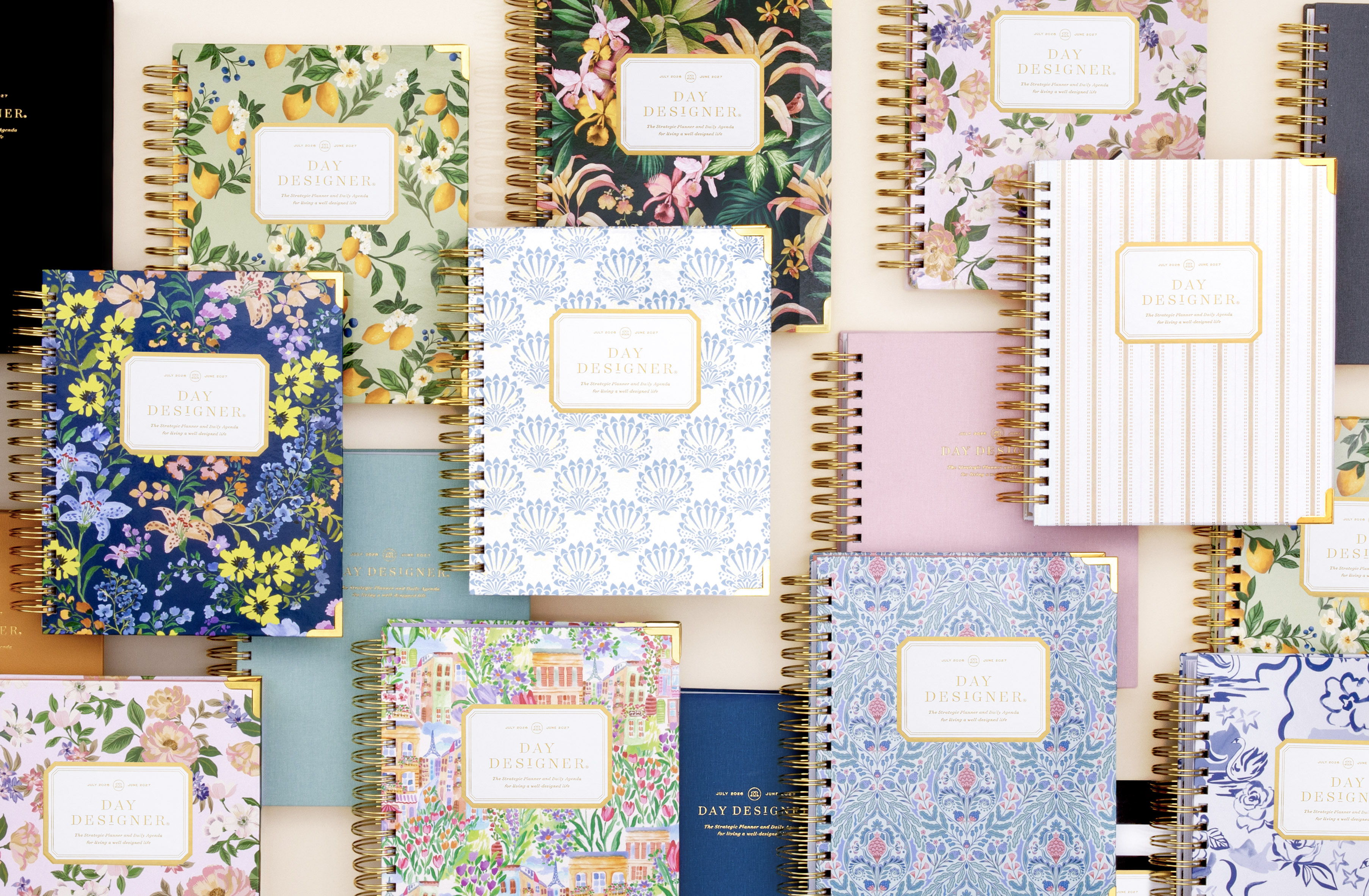 2026-27 day designer planners, stacked in assorted colors and patterns