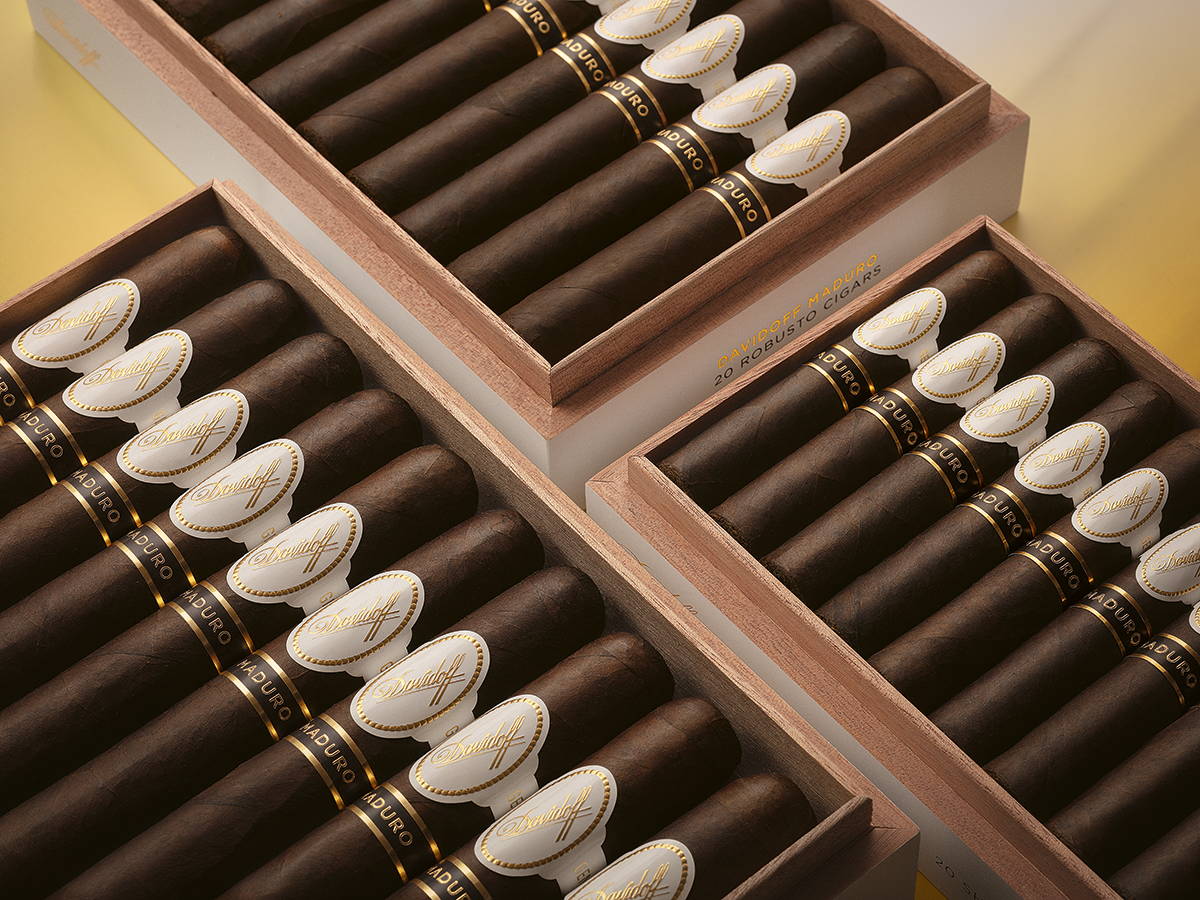 Three opened boxes of Davidoff Maduro with cigars inside next to one another. 
