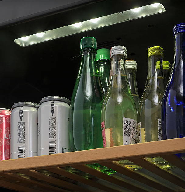 Recessed LED lighting illuminating a fully stocked shelf of beverages.