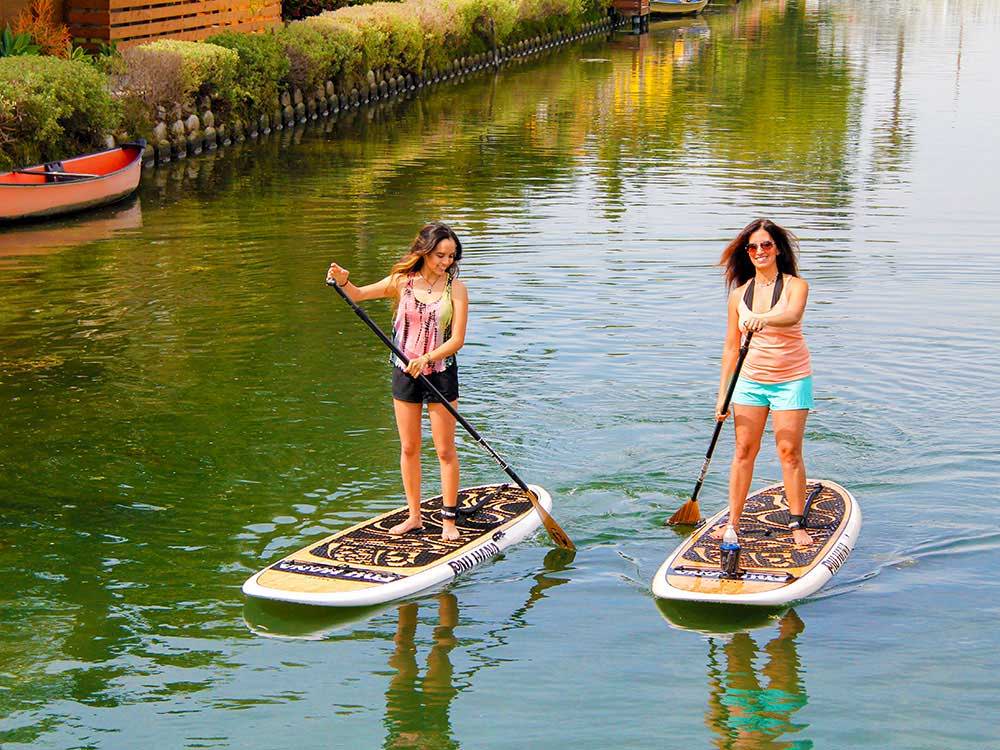 two people paddling the oahu paddleboard in venice california