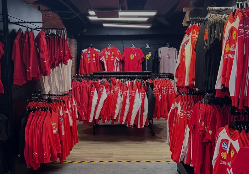 A clothing display featuring various red shirts arranged on hangers.