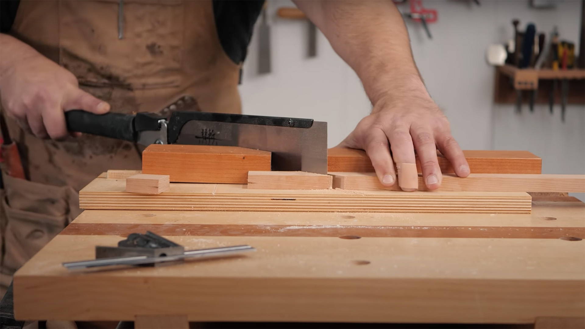 cutting a frame miter on a magnetic crosscut jig for hand saws