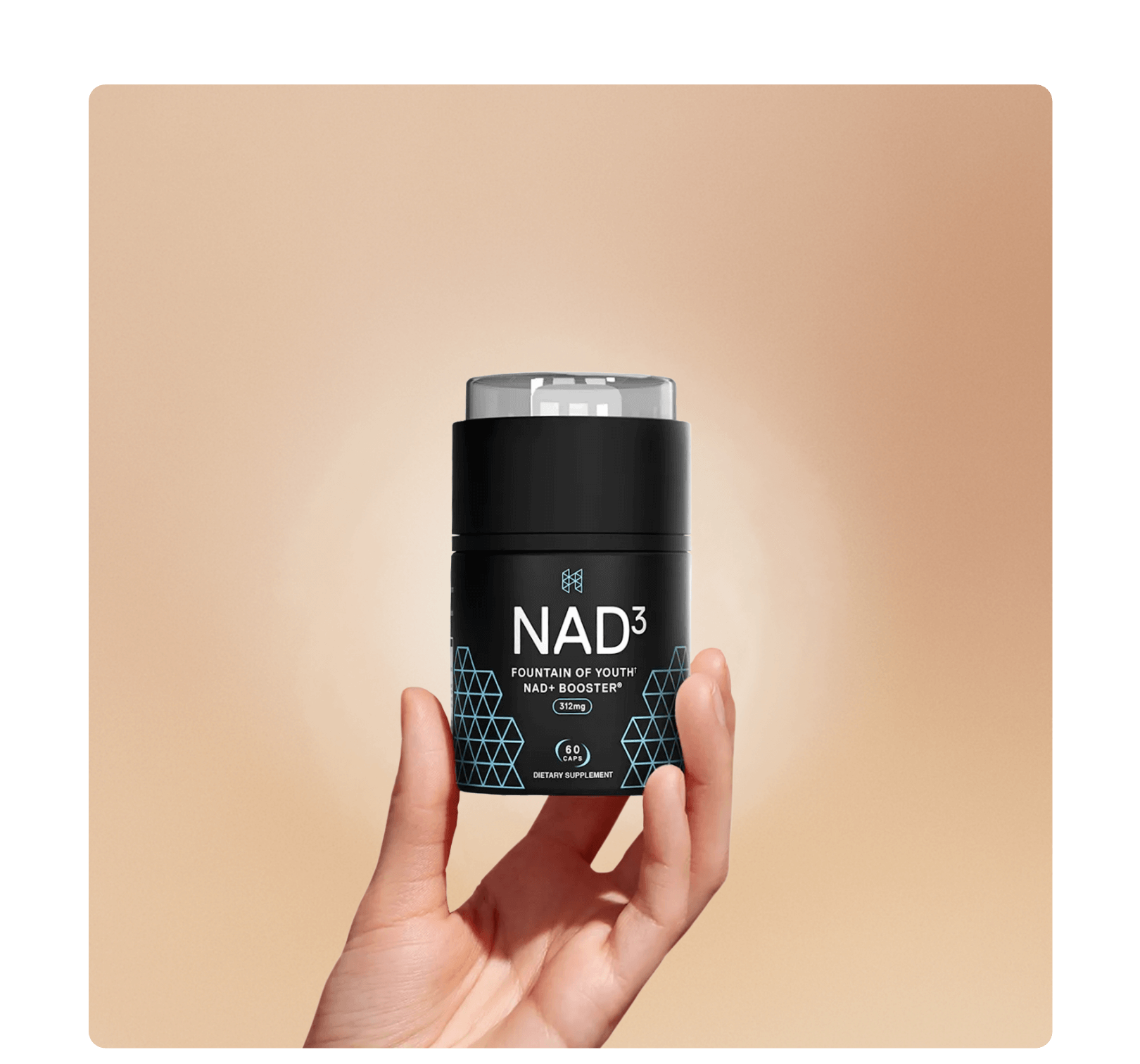 A hand holding a black container labeled 