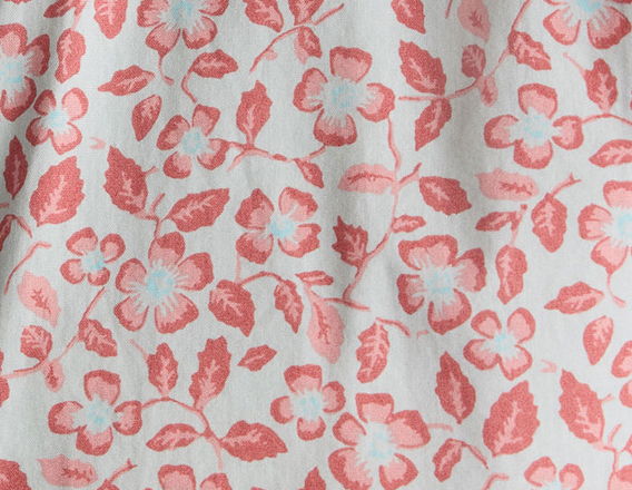 Floral pattern with pink and blue flowers on a light background.