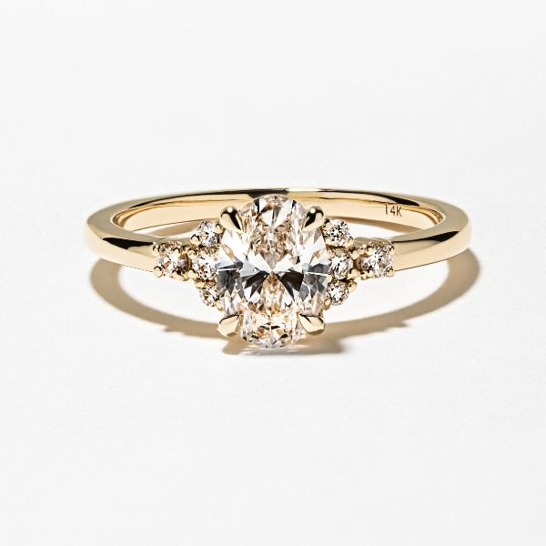 Custom lab grown diamond engagement ring with accenting diamonds in a 14k yellow gold band