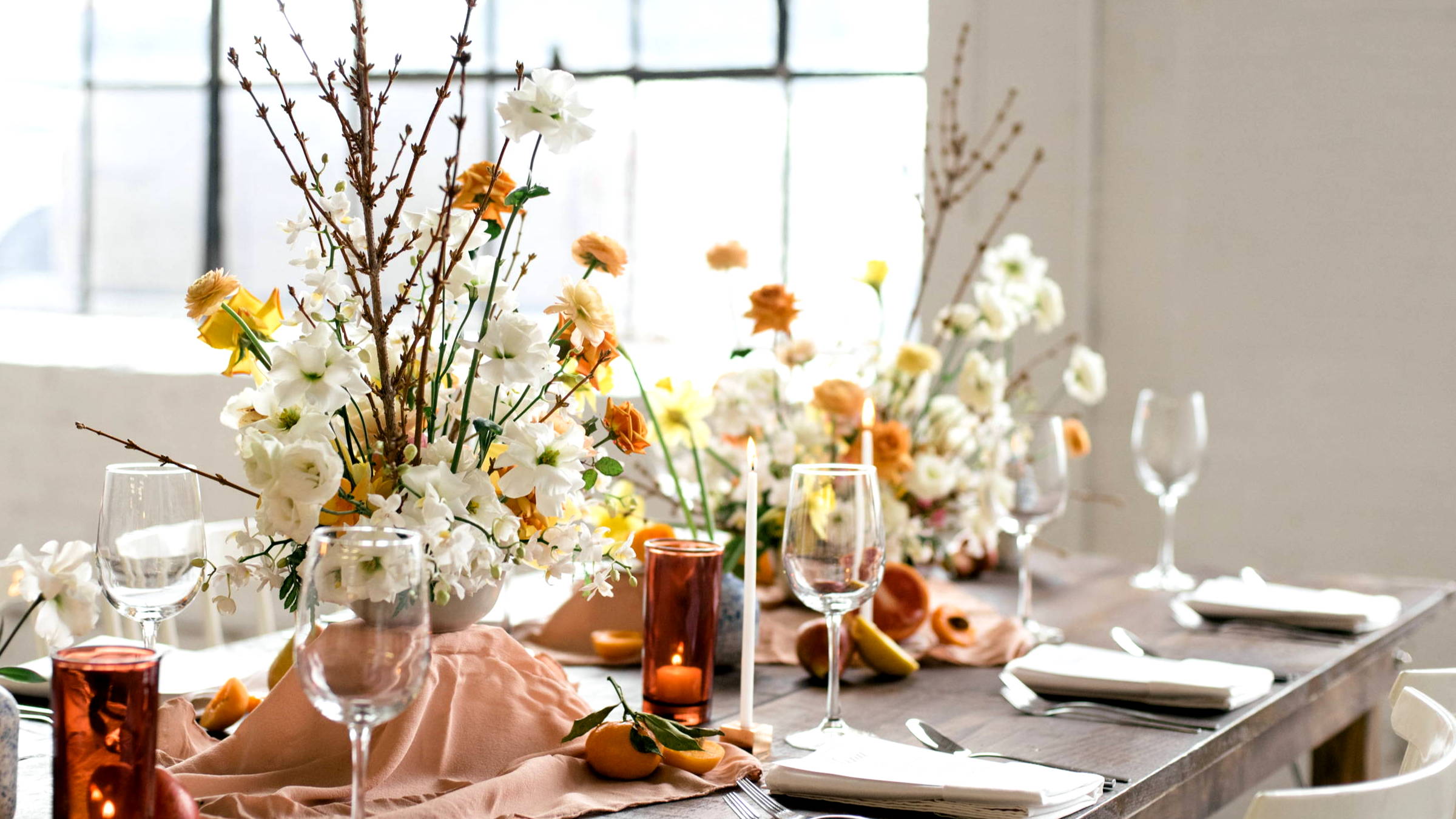 White, Orange, Yellow Tablescape with Two Arrangements, Wine Glasses and Candles