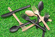 Brown and black PLA cutlery in a pile
