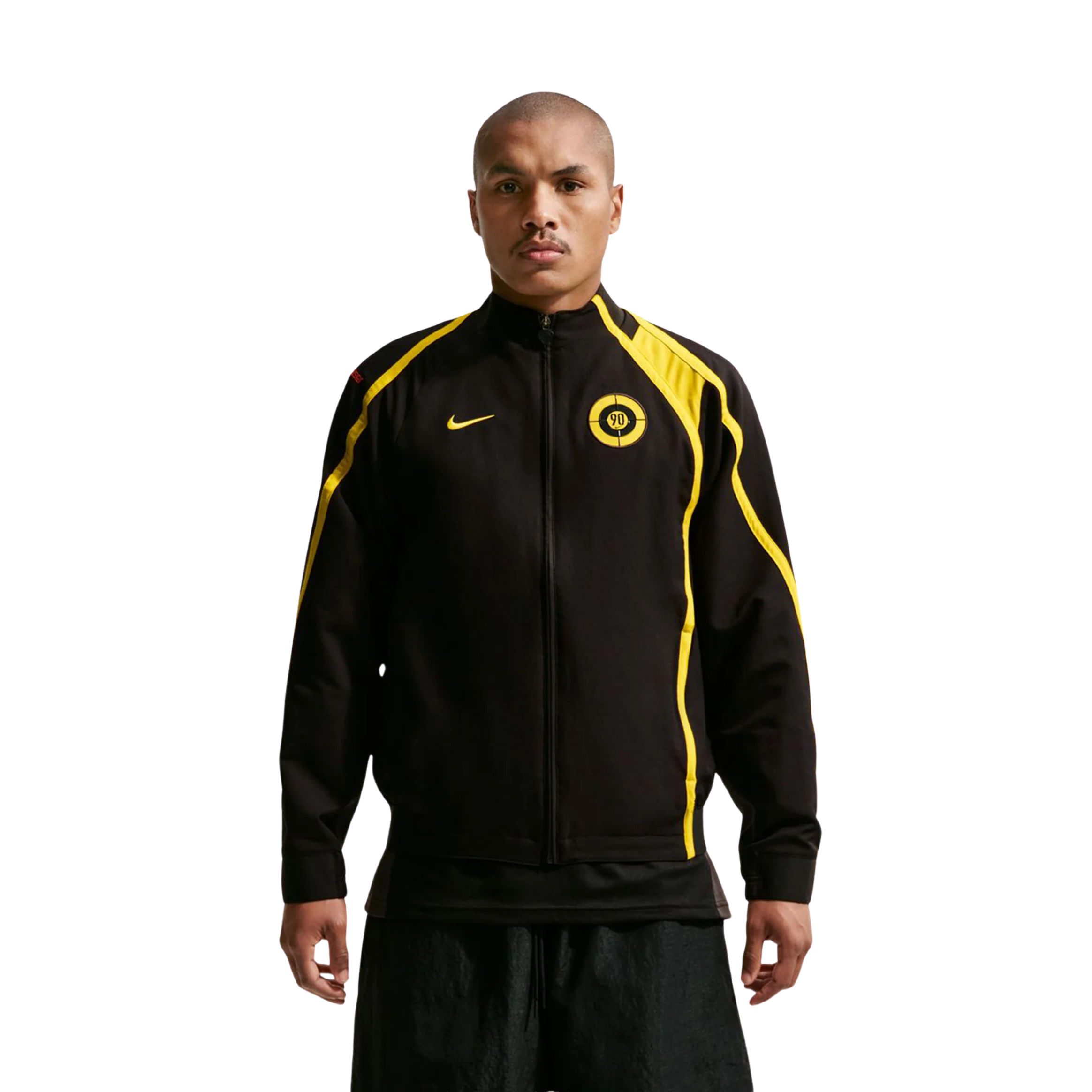 Person wearing a black and yellow Nike jacket.